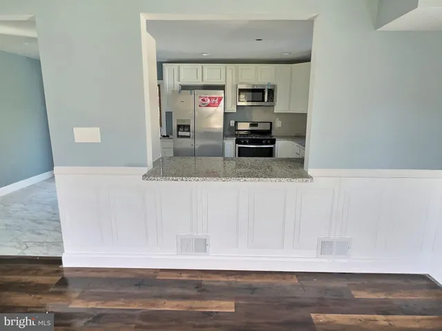 a view of a refrigerator a sink and dishwasher