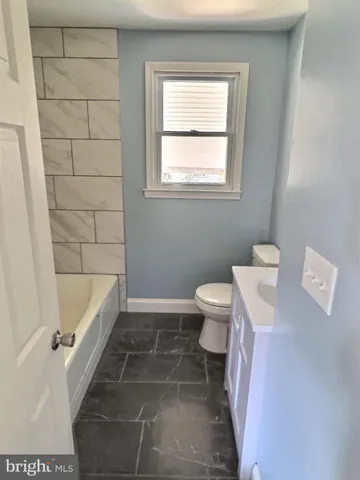 a bathroom with a toilet a sink a bath tub and shower