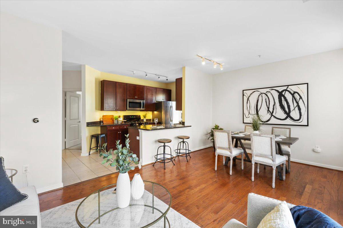 8045 Newell Street, Unit 107 Silver Spring, MD 20910 - Photo 13 of 75 a living room with furniture and wooden floor
