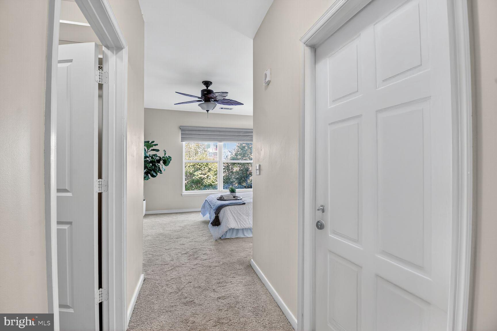 8045 Newell Street, Unit 107 Silver Spring, MD 20910 - Photo 23 of 75 a view of a hallway with wooden floor and a livingroom