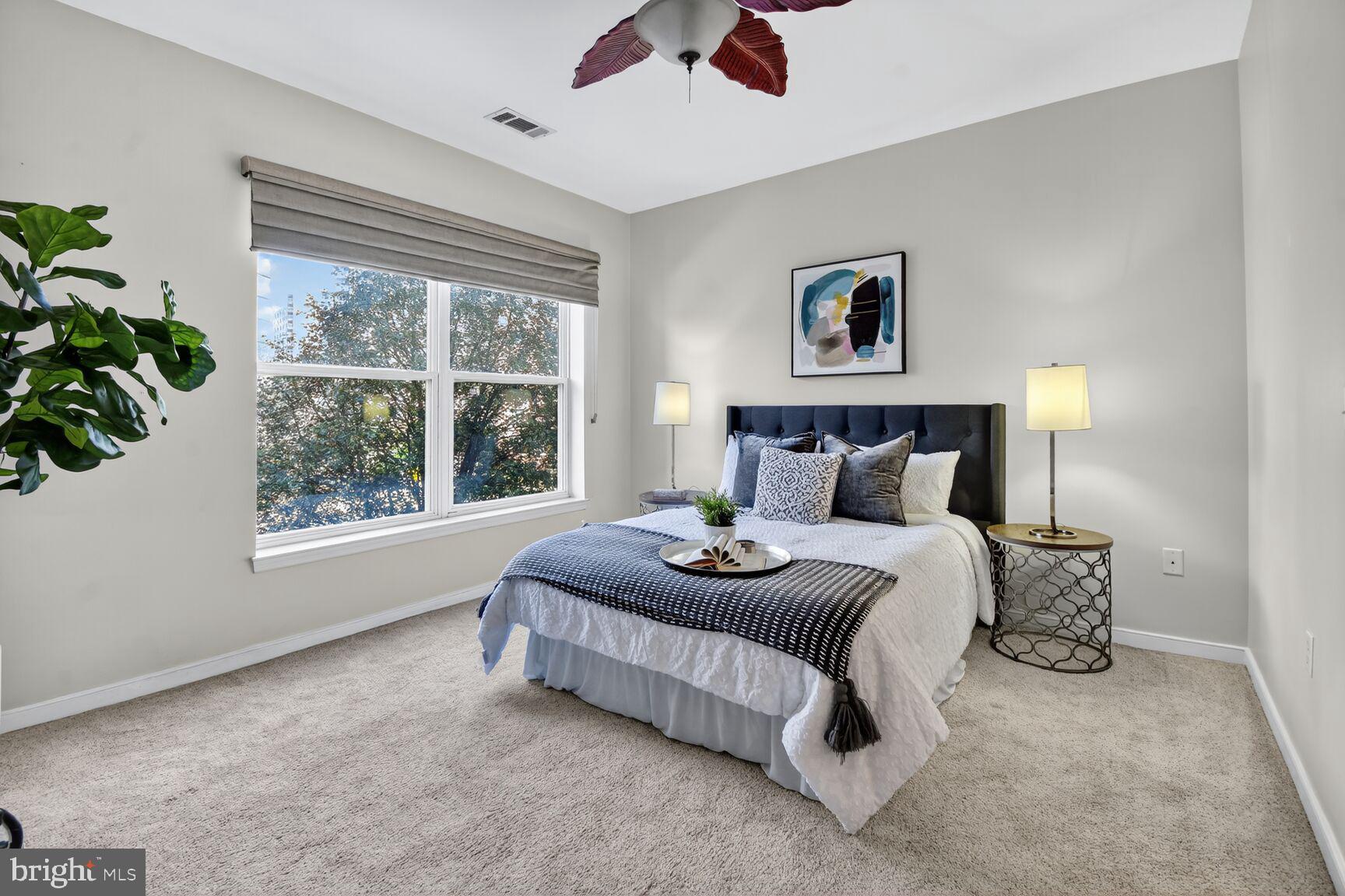 8045 Newell Street, Unit 107 Silver Spring, MD 20910 - Photo 26 of 75 a bedroom with a bed and a window