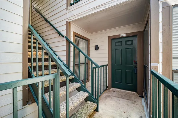 a view of staircase with railing and white walls