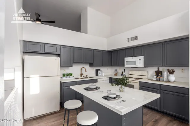 a kitchen with a refrigerator a stove a sink dishwasher and white cabinets with wooden floor