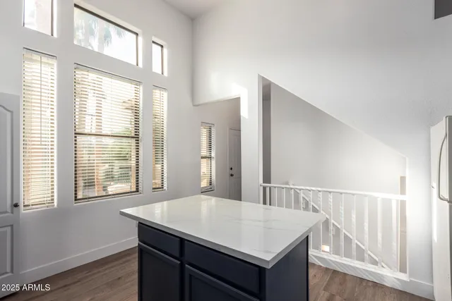 a view of a kitchen that has a sink a window and wooden floor