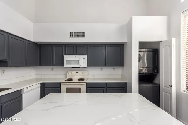 a kitchen with a refrigerator and a stove top oven