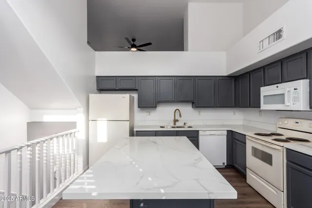 a kitchen with a sink a stove and cabinets