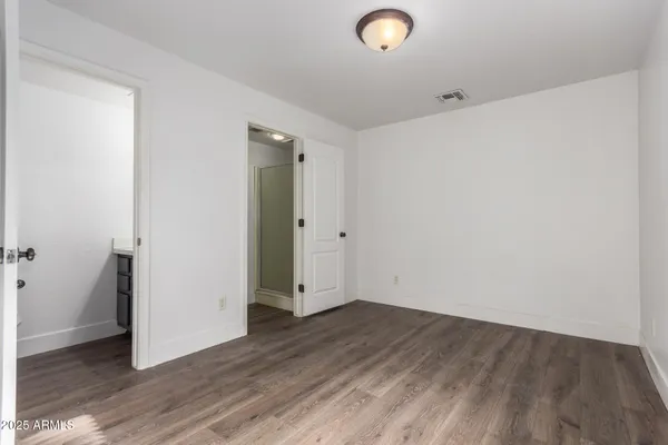 an empty room with wooden floor
