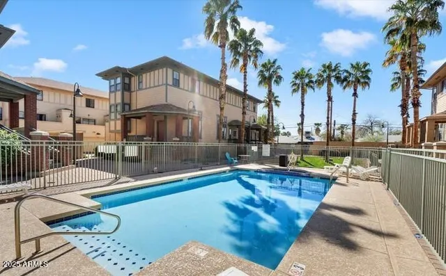 a view of a house with swimming pool and sitting area