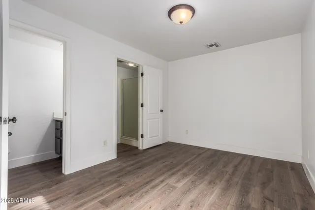 an empty room with wooden floor