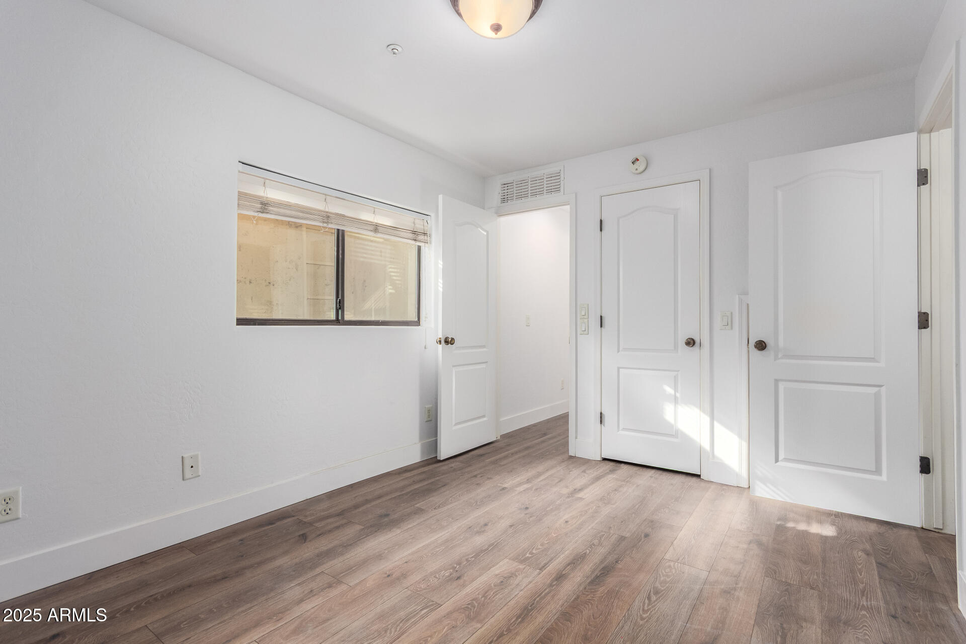 738 South Beck Avenue Tempe, AZ 85281 - Photo 23 of 31 a view of an empty room with wooden floor