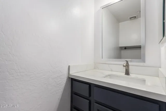 a bathroom with a sink and mirror