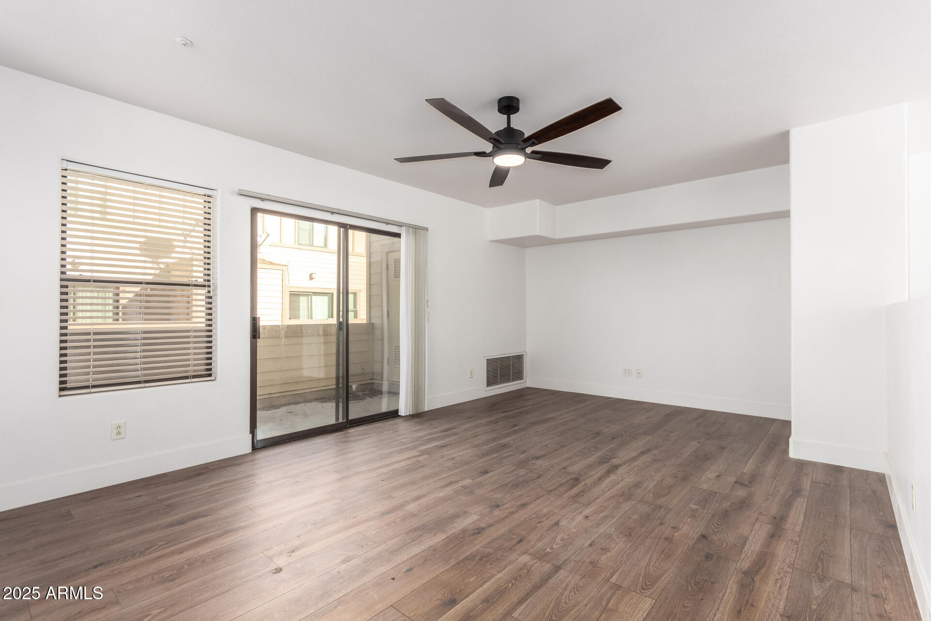 738 South Beck Avenue Tempe, AZ 85281 - Photo 8 of 31 a view of an empty room with a window and wooden floor