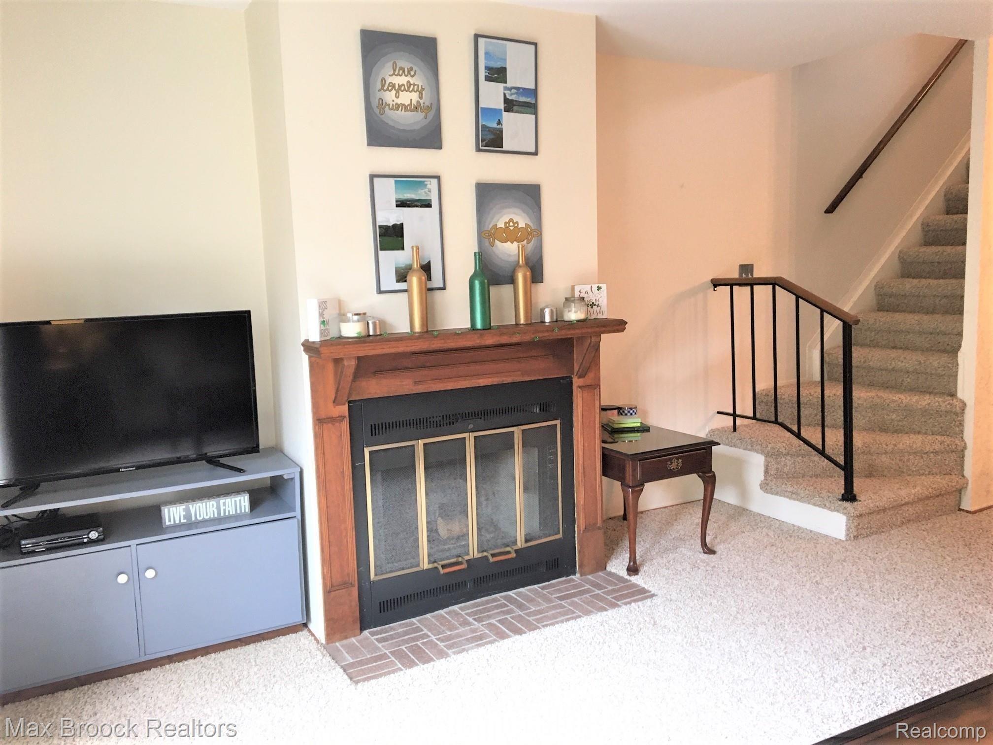 1472 West Webster Road, Unit 10 Royal Oak, MI 48073 - Photo 5 of 14 Natural fireplace with mantel. You can see an area next to it where shelving could be added, if you'd like.