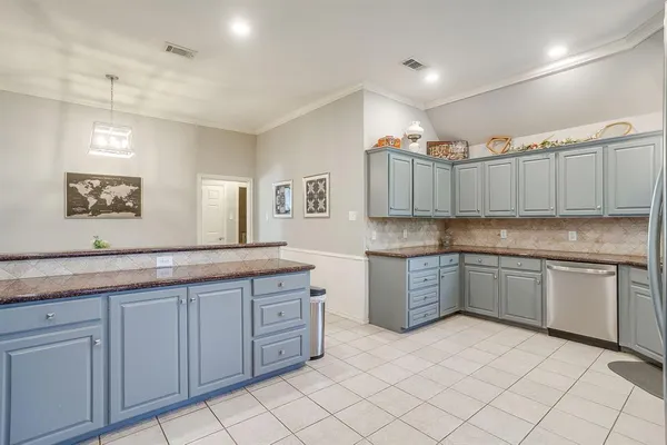 a kitchen with granite countertop cabinets and window