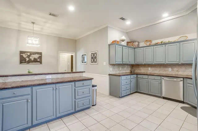 a kitchen with granite countertop cabinets and window