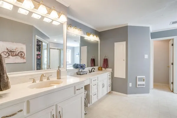 a bathroom with double sink and a mirror