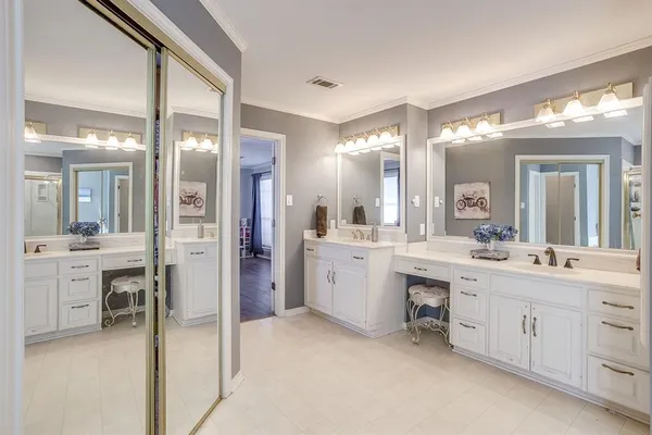 a large bathroom with a large mirror vanity and shower