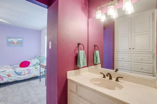 a bathroom with a sink vanity and a mirror