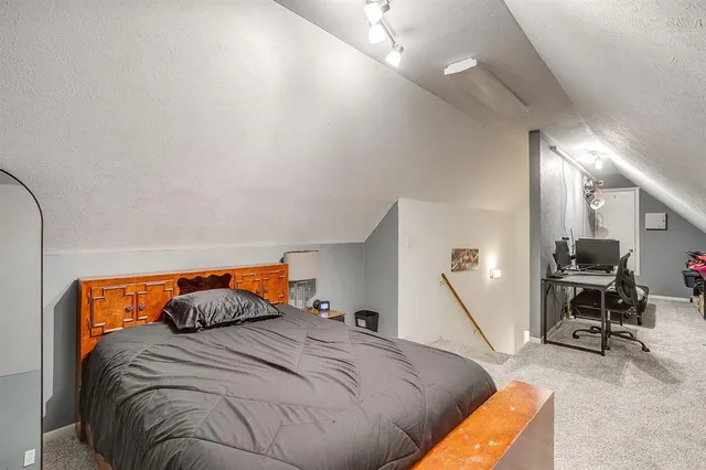 a bedroom with a bed and chair