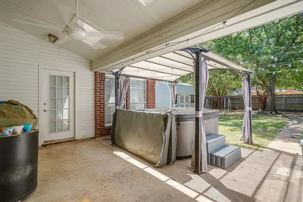 a view of a porch with furniture and garden
