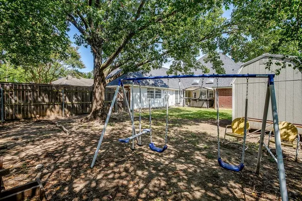 front view of a house with a large tree