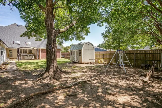 a view of a house with backyard and a tree