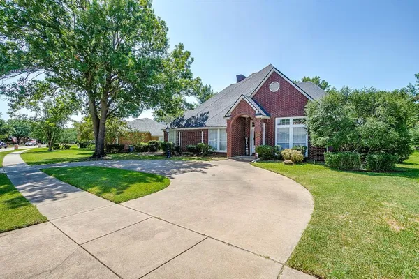 a front view of a house with yard and green space