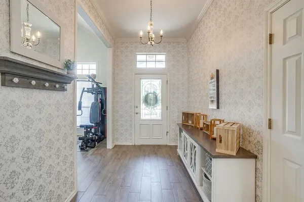 a hallway with a window and wooden floor
