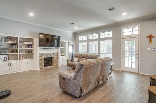 a living room with furniture a fireplace and a flat screen tv
