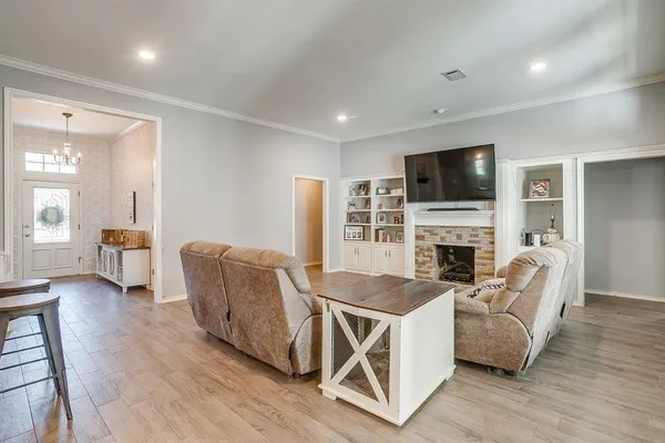 a living room with furniture a fireplace and a flat screen tv