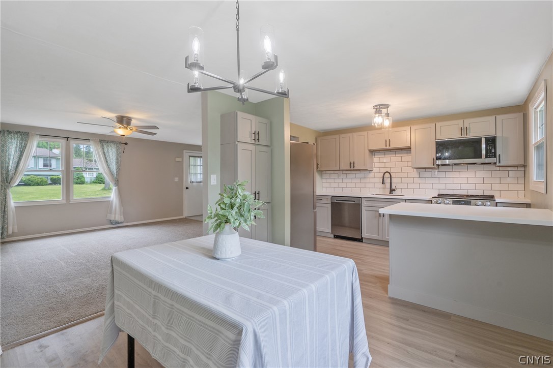 114 Saltwell Road Salina, NY 13090 - Photo 5 of 27 Just beyond the living room, we enter the formal dining area. Just look at the modern fixtures recently updated as part of the full kitchen remodel. Luxury vinyl flooring is equal parts attractive and durable.