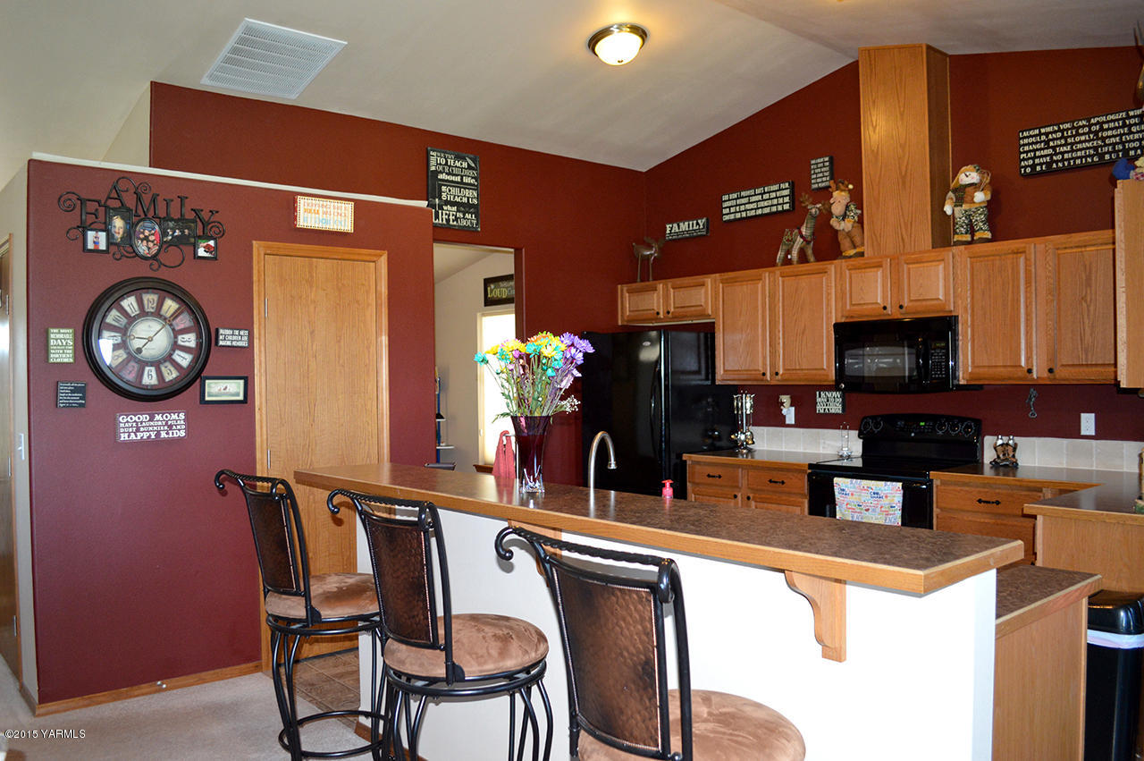 328 Cornue Road Zillah, WA 98953 - Photo 4 of 21 a kitchen with stainless steel appliances granite countertop a dining table and chairs
