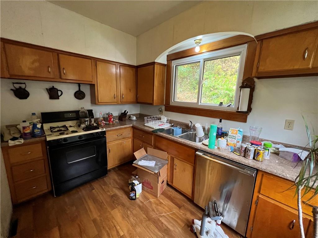 147 Clarks Pike Road Creighton, PA 15030 - Photo 7 of 26 a kitchen with stainless steel appliances a stove a sink dishwasher and cabinets with wooden floor