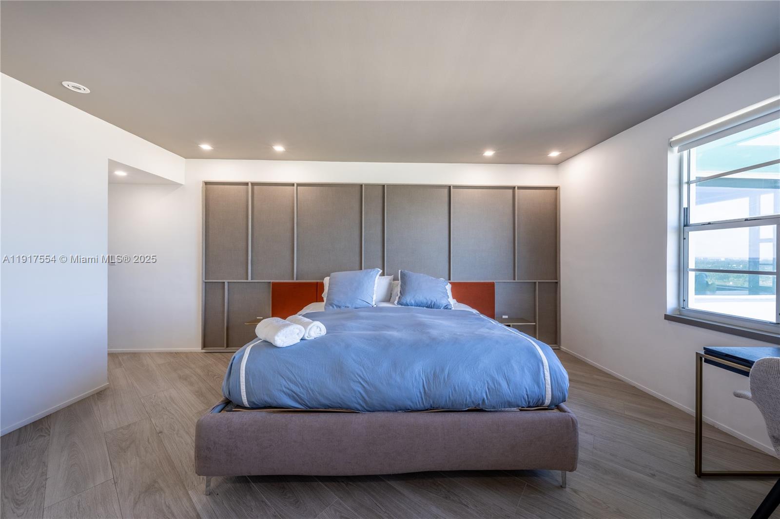 5255 Collins Avenue, Unit 12F Miami Beach, FL 33140 - Photo 18 of 45 a bedroom with a bed and a window