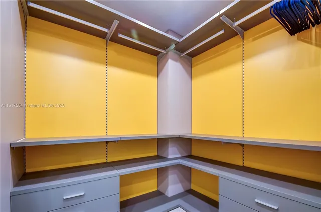 a kitchen view with a large window and cabinets