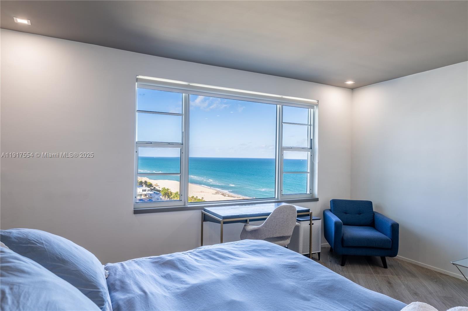 5255 Collins Avenue, Unit 12F Miami Beach, FL 33140 - Photo 23 of 45 a bedroom with a bed and a large window