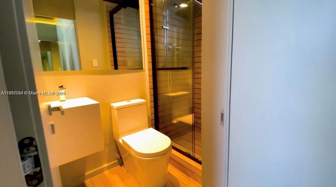 5255 Collins Avenue, Unit 12F Miami Beach, FL 33140 - Photo 37 of 45 a bathroom with a sink and a toilet