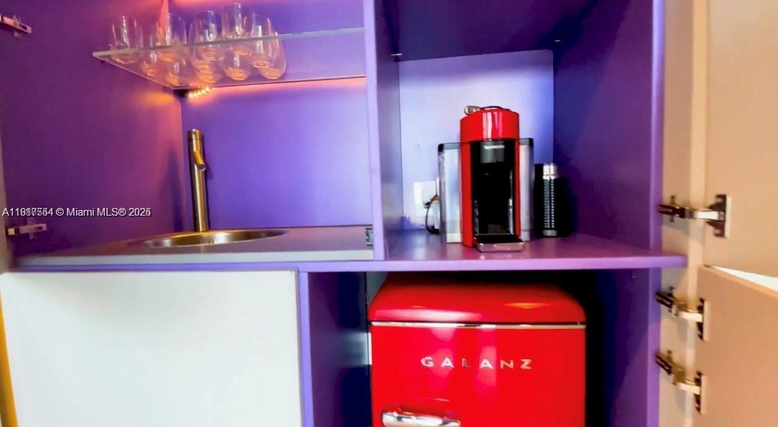 5255 Collins Avenue, Unit 12F Miami Beach, FL 33140 - Photo 39 of 45 a bathroom with a sink and a mirror