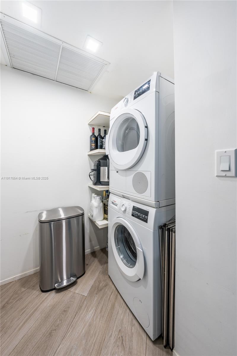 5255 Collins Avenue, Unit 12F Miami Beach, FL 33140 - Photo 10 of 45 a utility room with dryer and washer
