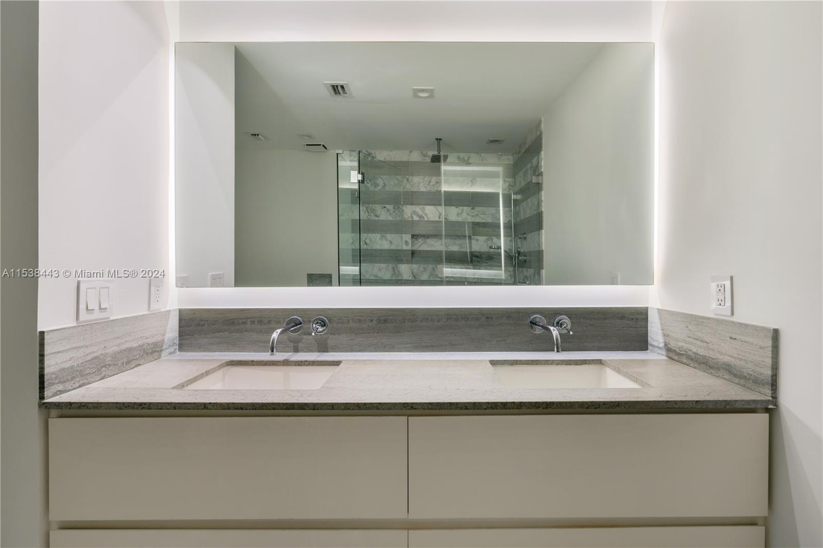 540 Brickell Key Drive, Unit 320 Miami, FL 33131 - Photo 16 of 32 a bathroom with a sink and a mirror
