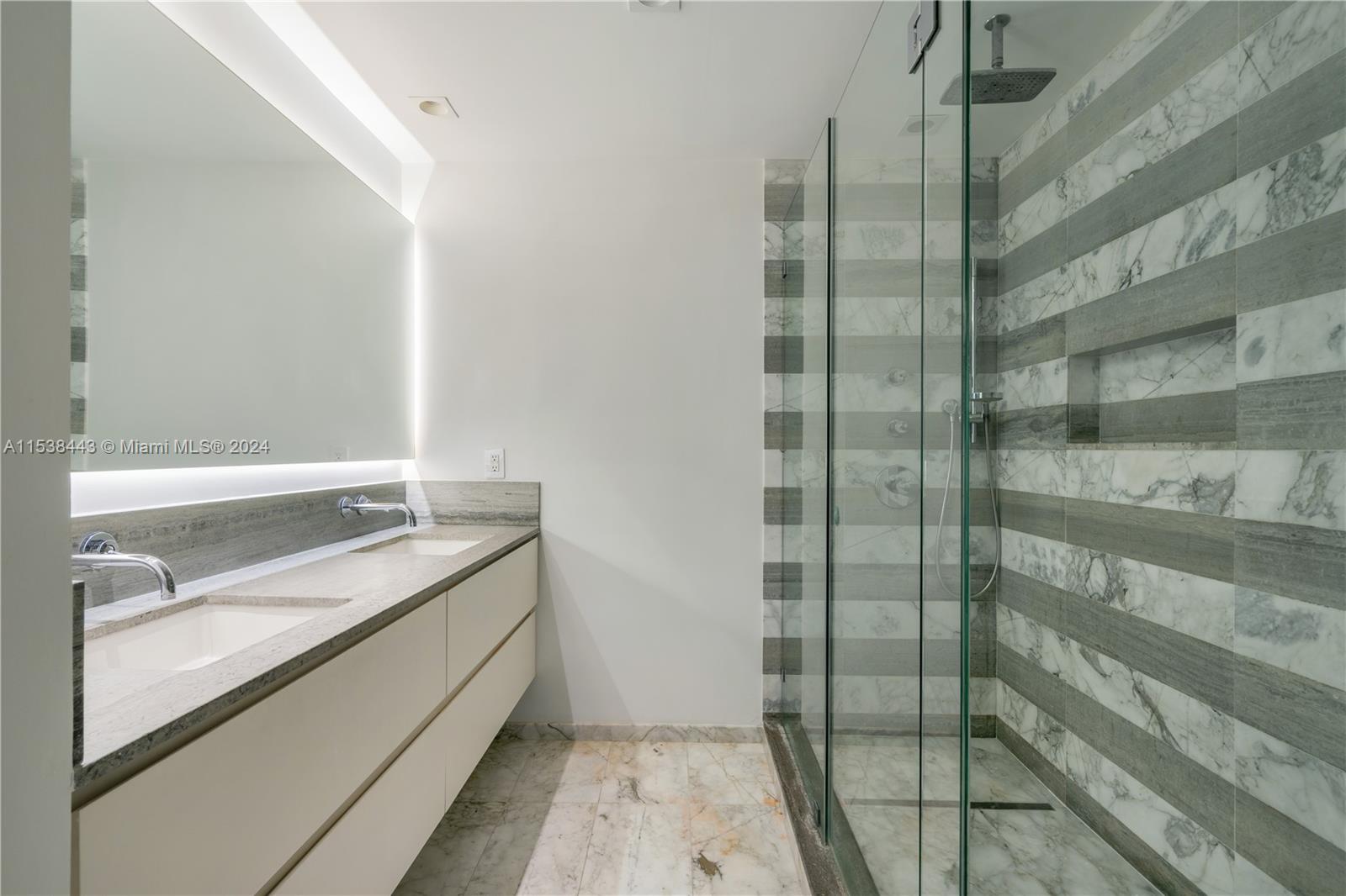 540 Brickell Key Drive, Unit 320 Miami, FL 33131 - Photo 17 of 32 a bathroom with a granite countertop sink and shower