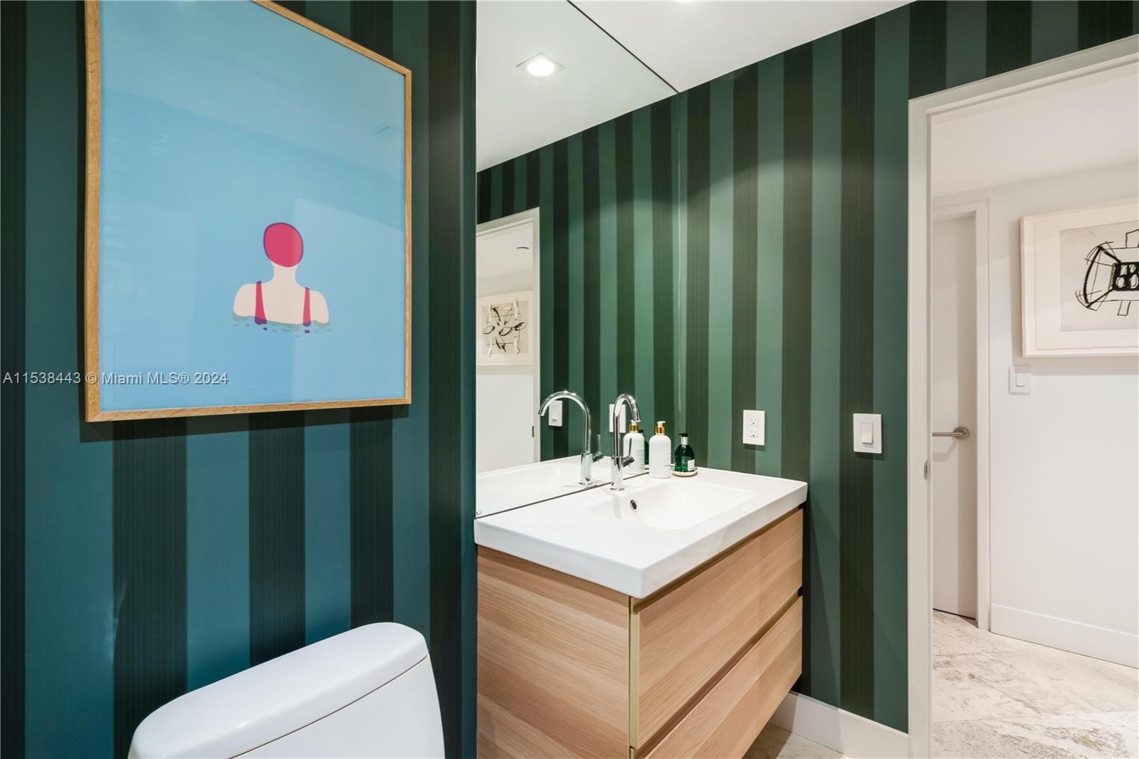 540 Brickell Key Drive, Unit 320 Miami, FL 33131 - Photo 20 of 32 a bathroom with a sink and a mirror