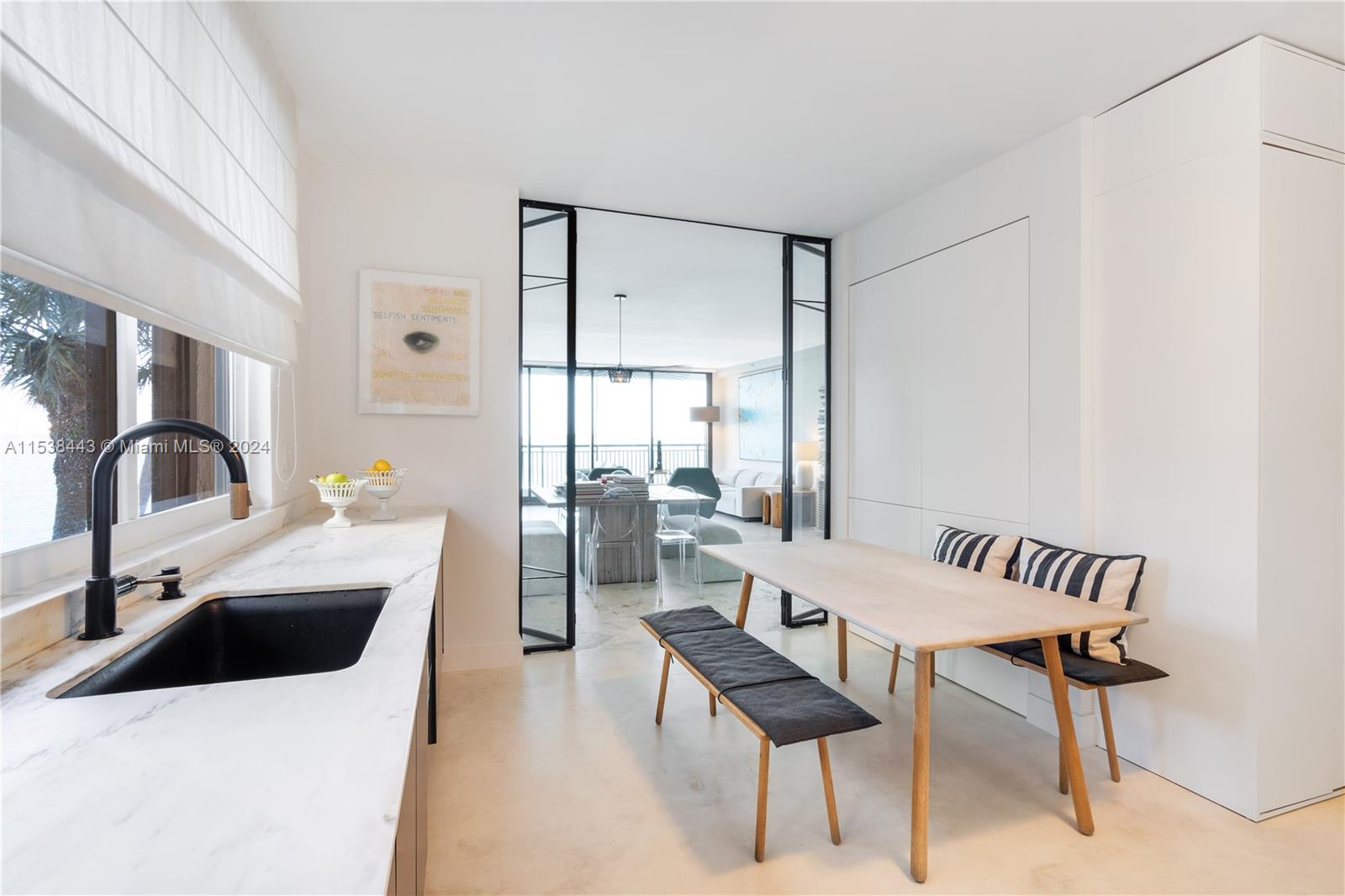 540 Brickell Key Drive, Unit 320 Miami, FL 33131 - Photo 4 of 32 a kitchen that has a sink and a table in it