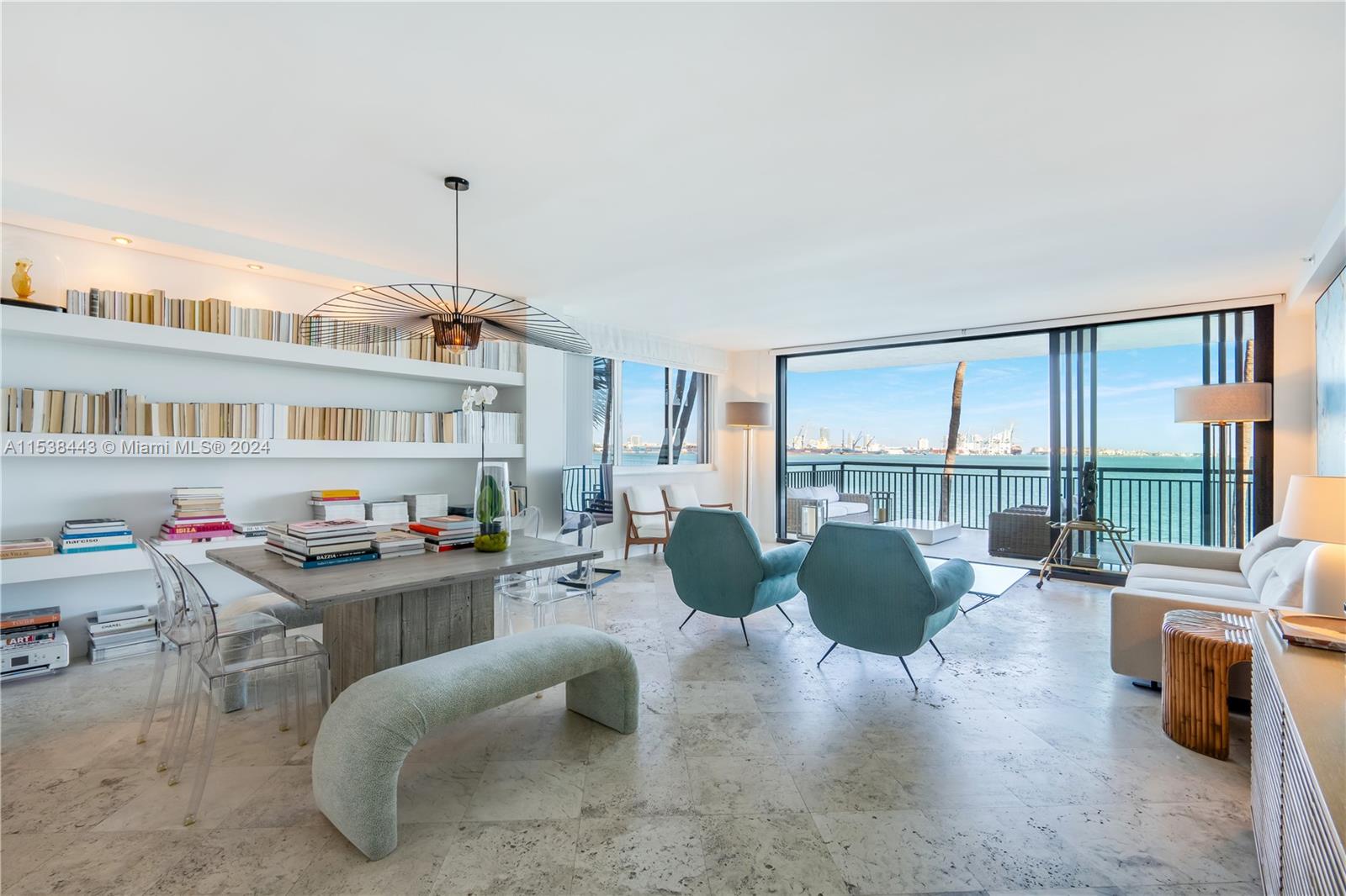 540 Brickell Key Drive, Unit 320 Miami, FL 33131 - Photo 5 of 32 a living room with furniture a floor to ceiling window and a flat screen tv