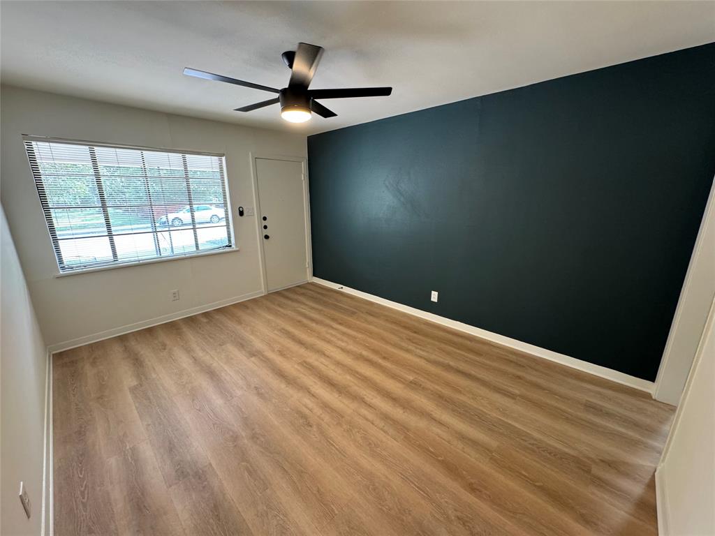 906 East 46th Street, Unit B Austin, TX 78751 - Photo 1 of 11 an empty room with windows and fan