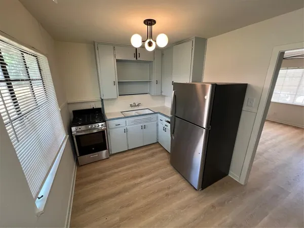 a kitchen with a refrigerator a sink and a stove