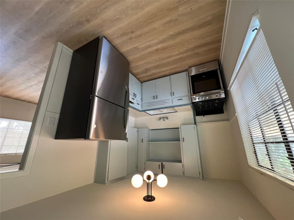 906 East 46th Street, Unit B Austin, TX 78751 - Photo 2 of 11 a kitchen with a refrigerator a sink and a stove