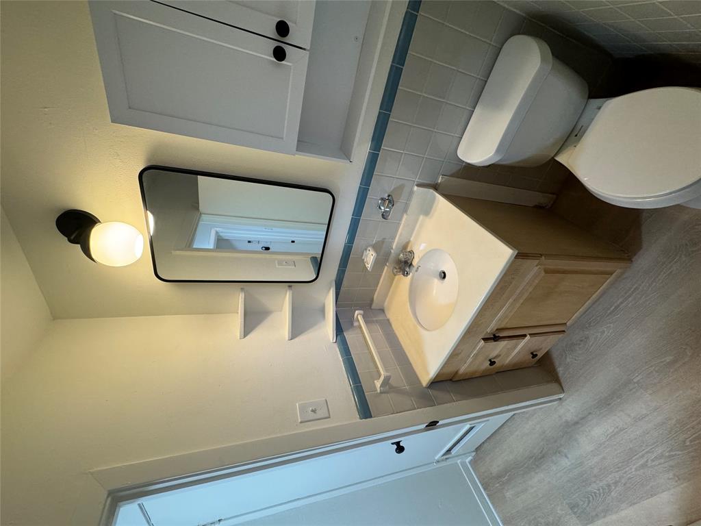 906 East 46th Street, Unit B Austin, TX 78751 - Photo 6 of 11 a bathroom with a toilet sink and mirror