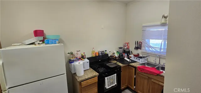 a utility room with sink dryer and washer