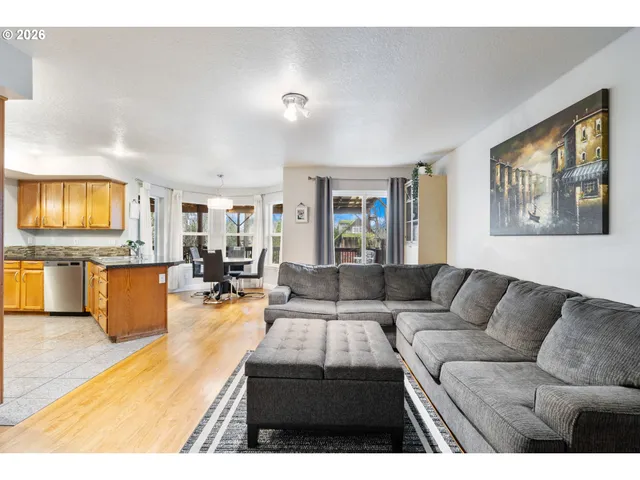 a living room with furniture and kitchen view